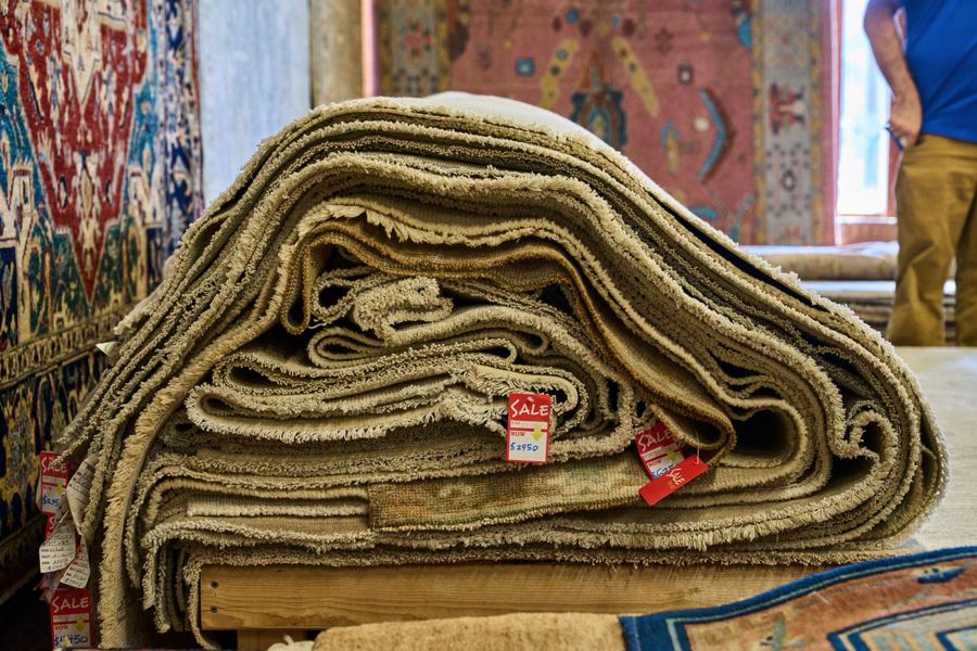 Folded rugs showing their weave