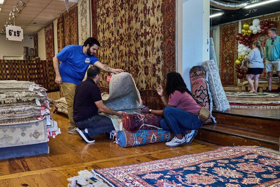 Guests sitting with rugs on the gallery floor